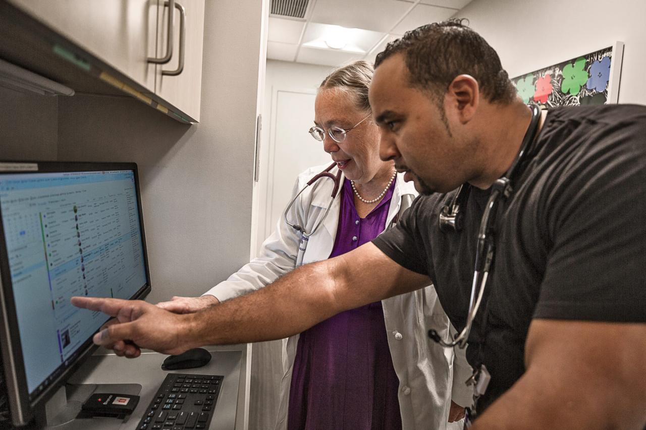 Doctors Review Chart on Computer Screen