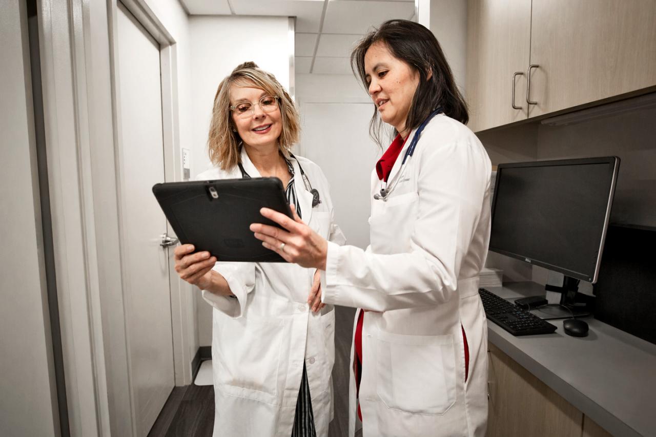 Dr. Dellis Norwood-Galloway and Dr. Phyllis M. Kwok Review a Chart